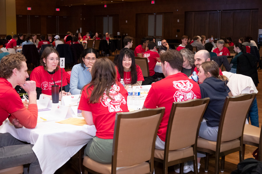 A group of participants have a discussion at a table