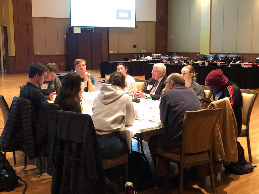 10 people are sitting around a table, including the Universities of Wisconsin President.